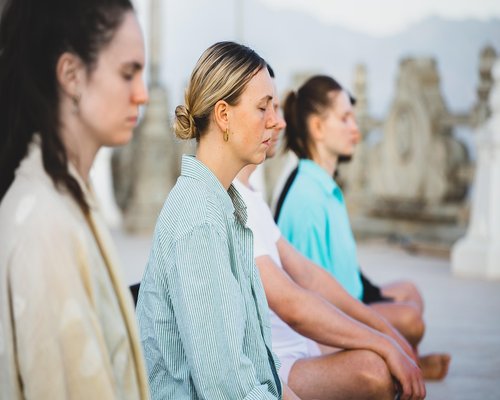 Group of women practicing yoga in a bright open room